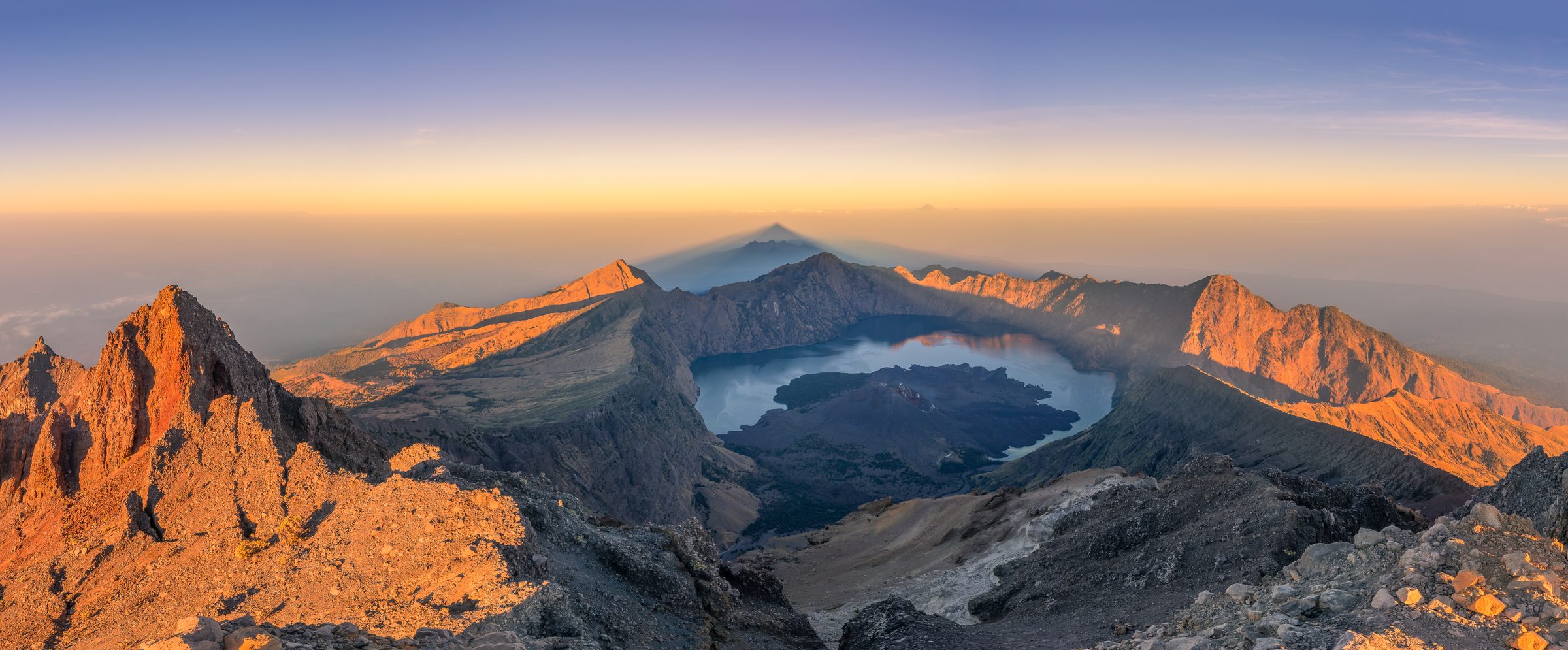 Panoramic view of Rinjani crater and Segara Anak lake at sunrise