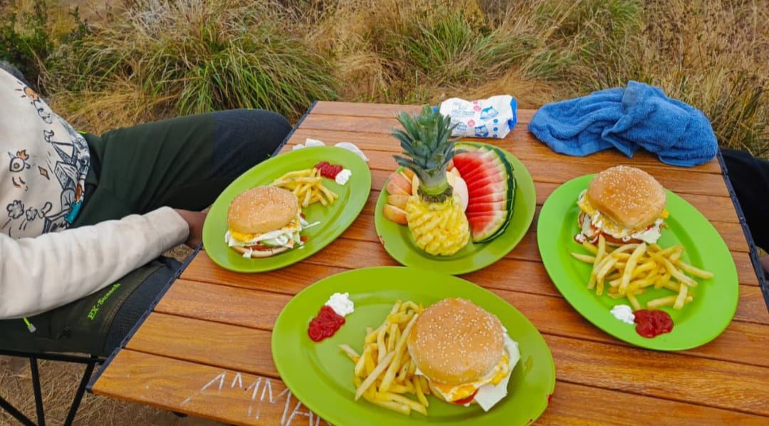Fresh meals served at the crater rim camp: burgers, fries and carved fruit