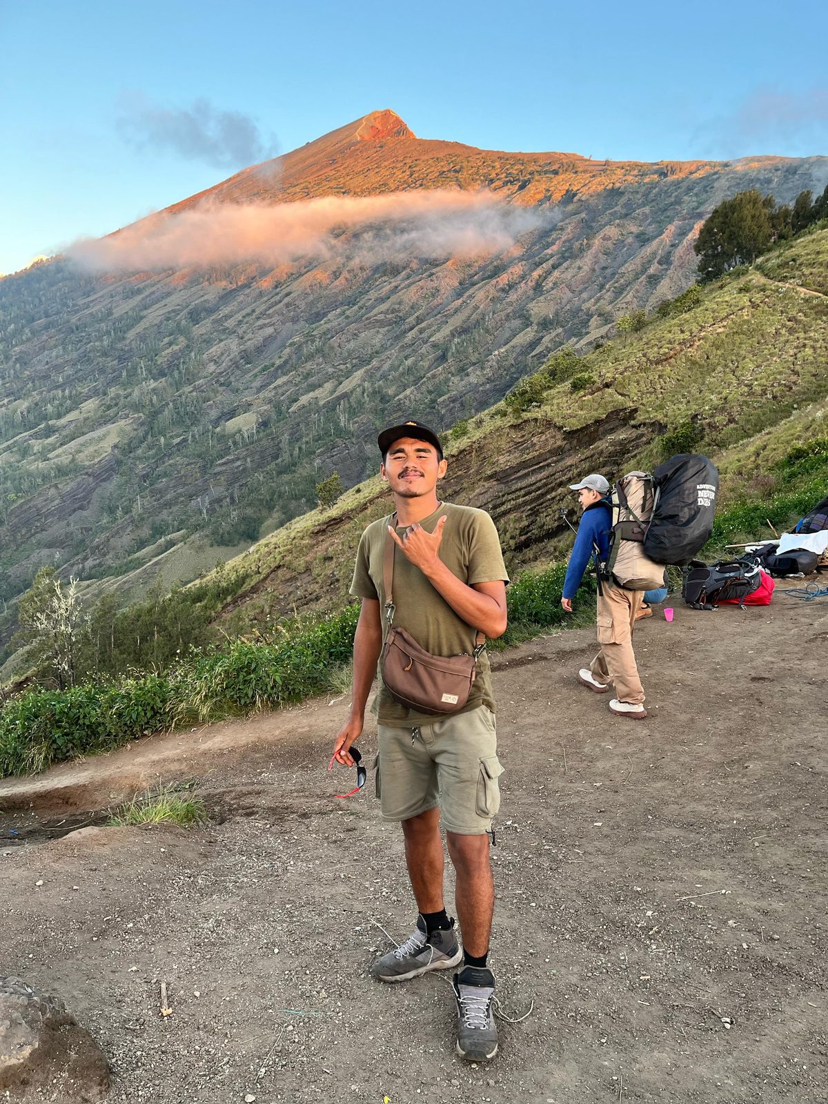 Zaenal — lead guide on the Rinjani trek, standing on the crater rim