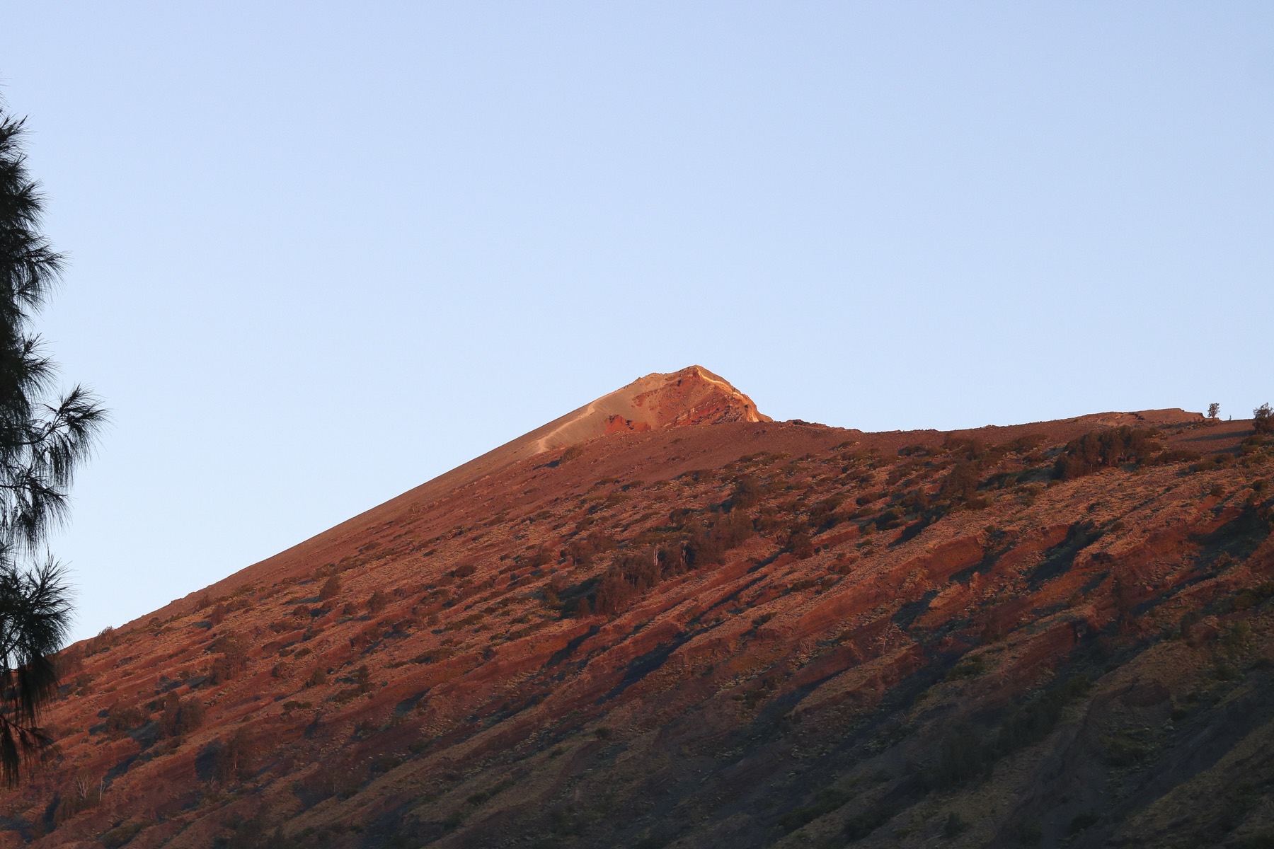 The summit ridge of Rinjani lit gold at sunrise