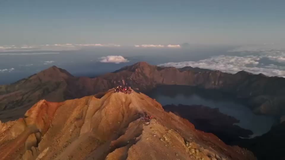 Segara Anak crater lake seen from the rim, with the summit cone behind it